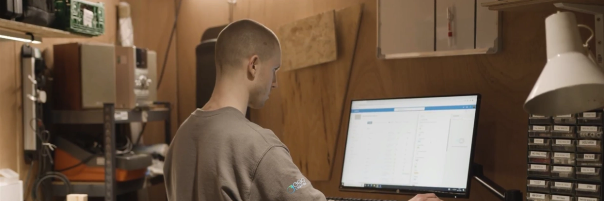 Tom at the EGG Lighting workshop bench — assessing luminaires for remanufacture
