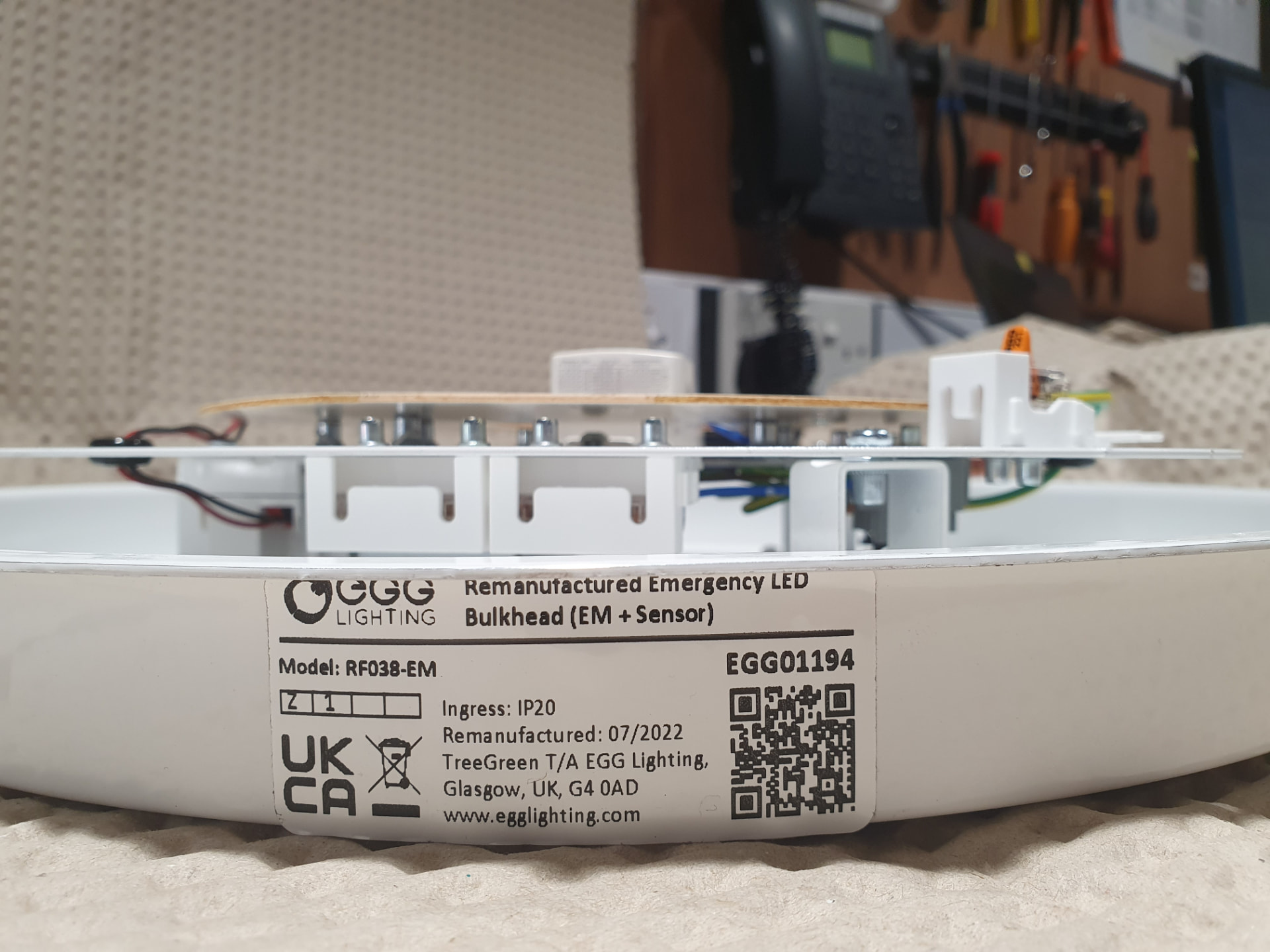 Remanufactured emergency LED bulkhead with EGG Lighting product label