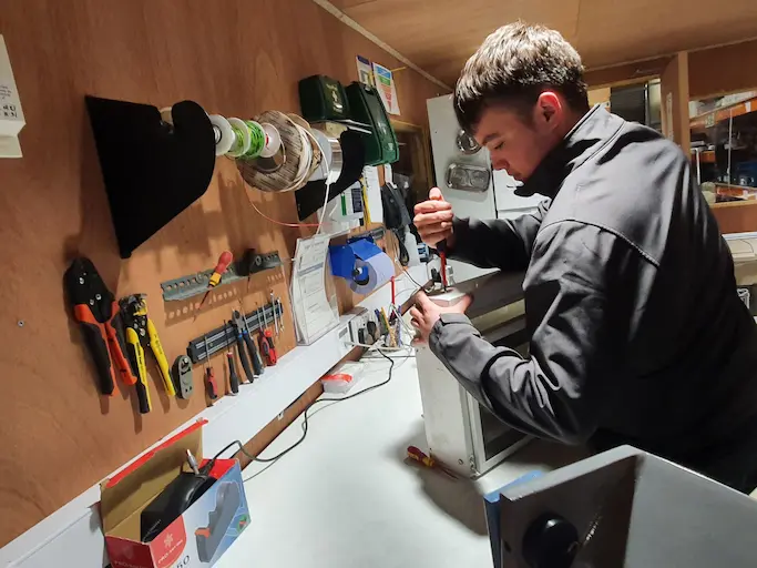 EGG electrician carrying out electrical works at the bench