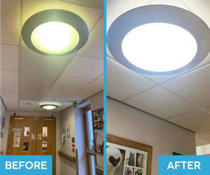 Side-by-side comparison of a yellowed, dim fluorescent bulkhead and a bright LED remanufactured version